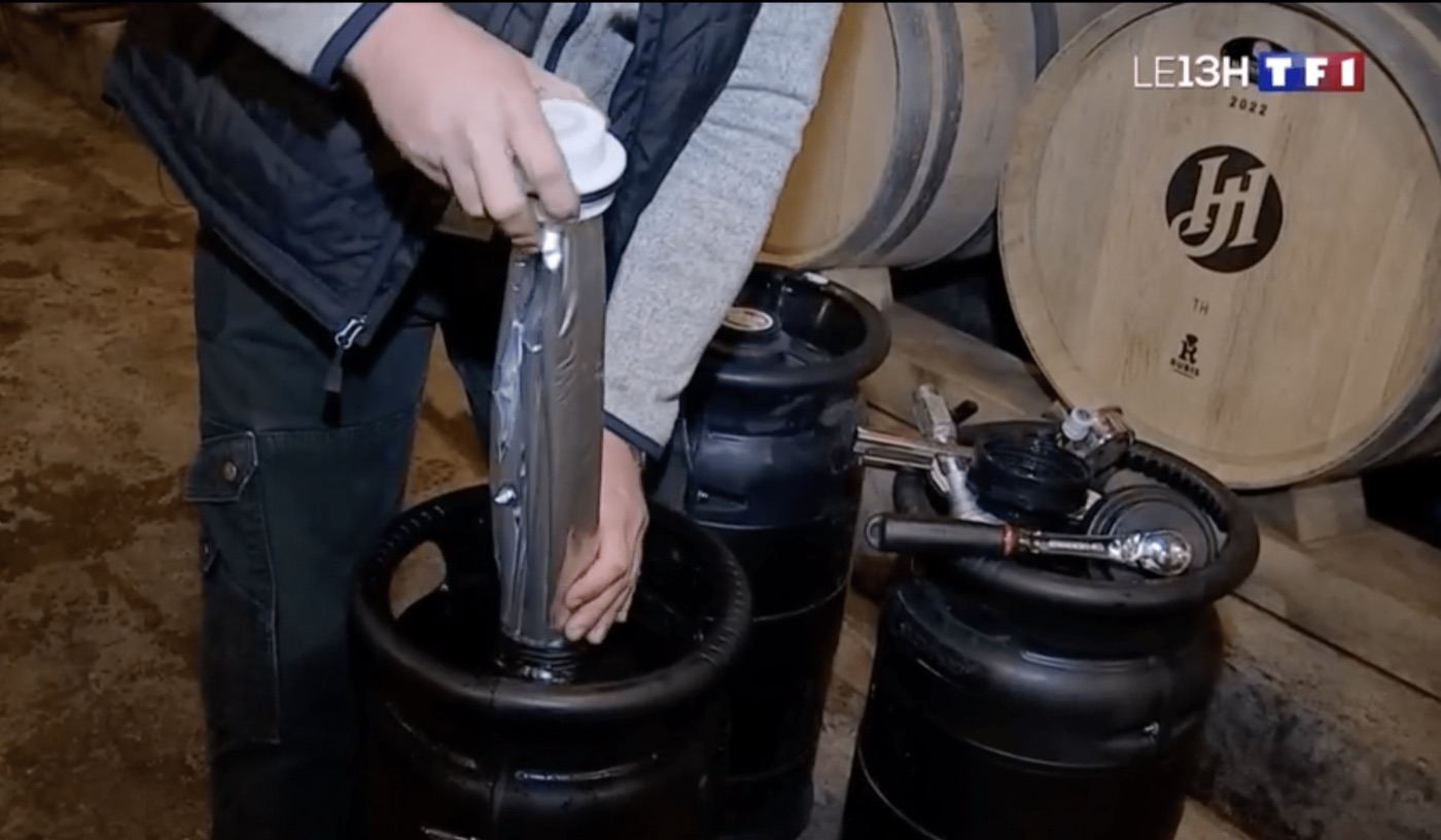 Extrait du JT de 13 h de TF1 : une poche de vin est insérée dans un fût ECOFASS, dans un chai